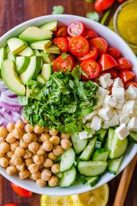 Chickpea Salad loaded with crisp cucumbers, juicy tomatoes, creamy avocado, feta cheese and chickpeas or garbanzo beans. Fresh, healthy and protein packed! #chickpeasalad #garbanzobeansalad #chickpeas #chickpeasaladrecipe #salad #saladrecipe #fetacheese #tomatosalad #avocadosalad #greeksalad #mediterraneansalad #natashaskitchen