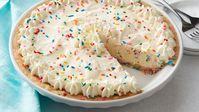 This colorful cookie pie is ready to party! Speckled with fun, multi-colored sprinkles, this easy-to-make treat is perfect for birthdays (or any special day). The Pillsbury™ refrigerated sugar cookies crust studded with candy sprinkles starts things off on a sweet note, but the star of the show here has to be the filling—a sprinkles-packed, no-churn, homemade vanilla ice cream that’s surprisingly simple to make. Serve it topped with whipped cream and extra sprinkles for a treat that’s sure to