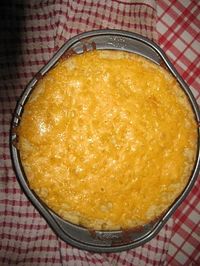 Southern Side Dish Corn Casserole 1 (15 1/4-ounce) can whole kernel corn, drained 1 (14 3/4-ounce) can cream-style corn 1 (8-ounce) package corn muffin mix (recommended: Jiffy) 1 cup sour cream 1/2 cup (1 stick) butter, melted 1 to 1 1/2 cups shredded Cheddar