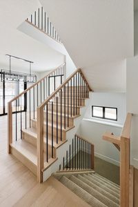 Captivating stair railing with a combination of natural wood and black metal spindles.