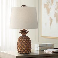 Enhance casual or coastal setting with this playful pineapple-shaped table lamp. Meticulously crafted for artistic quality, this contemporary table lamp shows off wonderful detail and dimensionality. The design topped with an oatmeal fabric shade and decorative finial.