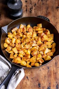 This simple Fried Potatoes and Onions recipe is tasty, easy, and only requires a few ingredients! Cubed potatoes and onions are pan-fried in a skillet with simple seasonings until golden brown and crispy. Serve this easy side dish with breakfast, lunch, or dinner!