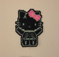 I made a spooky Kitty skeleton perler pattern for halloween. She is super cute and easy to make with only 1,583 perler beads and 4 boards. The pattern I made calls for black, white, and neon pink, but for my kitty pictured, I used regular glow beads, pink glow, and black. I added an example of what the pattern pdf will look like using a wonky smiley face.