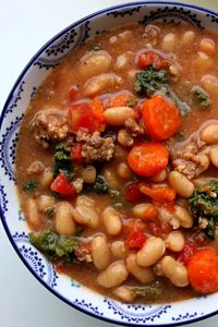 Instant Pot Tuscan Sausage White Bean Soup--dried white beans are quickly pressure cooked and make an amazing soup with Italian sausage, carrots, tomatoes, kale and parmesan cheese. The flavor is unbelievably good! This soup is naturally gluten free.