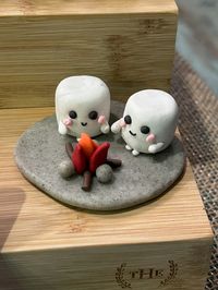 Scene of marshmallows sitting by a campfire. Made from polymer clay.