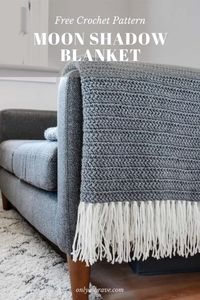 A modern crochet blanket pattern made from soft chunky yarn. Cosy up in this crochet throw. An easy beginner friendly crochet pattern! Made in one colour / color with a contrasting tassel fringe. This simple crochet blanket throw pattern is made using the herringbone double crochet stitch for a lovely woven look blanket.