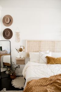 Easy DIY cane headboard to make all your boho bedroom wishes come true! Find the tutorial and step by step instructions at withrachlv.com.