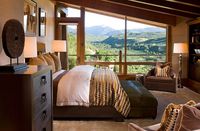 Bedroom of the vacation home with sloped ceiling and unabated mountain views | Wheeler Residence: Expansive Retreat with a Flair for the Dramatic! | Decoist