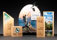 One of my personal favorite groups of awards we've done--this family lives on a shelf in our trade show booth. Most pieces are wood, but the back piece is layered acrylic. We were amazed and how well these pieces both engraved and color-fused.  #wood #engraving #laser #print #color #branding #outdoors #natural #awards