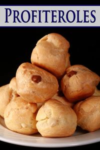 A pile of vanilla and chocolate cream filled profiteroles on a plate.