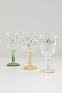 Create a garden party from your space with this stemmed wine glass featuring subtle fluted detailing and delicate flower motifs allover. Features Whimsical wine glass Glass construction with colorful finishes Floral motifs allover the cup Content + Care Glass Food safe Hand wash Not dishwasher, microwave or oven safe Imported Size 8.1 oz Dimensions: 3.23" dia x 6.25" h | Botanical Stemmed Wine Glass in Yellow at Urban Outfitters