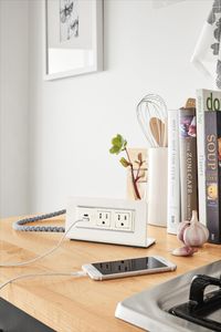 The Axil® power outlet provides freestanding table or desktop power that allows you to easily plug in laptops, phones and more - without having to fish under the table. Made in Michigan, Axil combines modern design, smooth anodized aluminum and an 8-foot braided cloth cord, as well as tamper-resistant outlets.