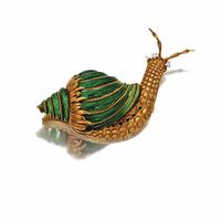 18 karat gold and enamel snail brooch, #DavidWebb The shell applied with translucent emerald green enamel, the eyes set with small round diamonds, signed Webb.