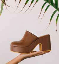 Clog-inspired vegan platform mule. Details: Synthetic leather upper Manmade outsole 3.5 in / 8.89 cm heel 1.5 in / 3.81 cm platform Synthetic leather lining Padded insole Slip-on style Imported