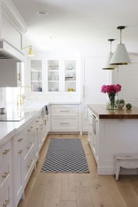 A classic white kitchen remodel with wood countertop island and brass hardware Photography : Studio McGee Read More on SMP: http://www.stylemepretty.com/living/2016/02/04/kitchen-dreaming-with-this-bright-classic-remodel/