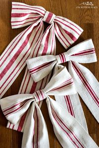 Easy step-by-step directions for making a grain sack ribbon bow from an antique grain sack or other fabric. No machine sewing required!