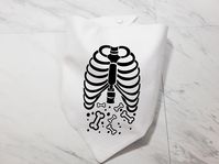 **All orders will have a production time of 4-7 business days starting in 2024. Please double-check your estimated delivery date before purchase. If you have any questions, please feel free to reach out.** Looking for a Halloween costume for your dog or pet that will be comfortable, but cute? Our Skeleton Bones Treat Bandana is perfect for the month of October! This fall bandana is perfect for dogs or cats that love treats and the scary season! Giving this item as a gift? We know it will be cherished for years to come!  This bandana has two layers of fabric to ensure durability. This bandana is sewn on all edges to ensure your scarf doesn't fray. All Whoa Dog E Bandanas come in sizes XS-L with custom sizes available at no extra cost. Each bandana also comes with 2 snaps on each side that a