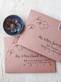 Personalize your special event with a handwritten calligraphy envelope that will set the tone for your guests. Say goodbye to boring wedding envelopes with these unique, modern yet classic floral wedding envelopes on dusty rose envelope.