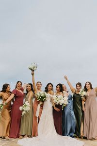 Gabby and John’s military wedding was full of lush greenery, mismatched jewel toned bridesmaid dresses, and all the partying you can imagine. To contrast the simple greens and whites of the florals, the bridesmaids wore mismatched dresses in jewel tones, in varying fabrics of satin, chiffon and crepe. The different colors paired perfectly with the groomsmen’s attire, most of which were in Air Force uniforms! To tie it all in, Gabby chose fluffy white bouquets for each of her girls.