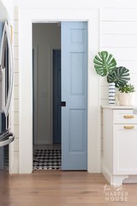 blue interior doors in this modern farmhouse laundry room makeover; click to see paint colors and all shopping sources on the blog! #modernfarmhouse #paintcolors #laundryroomideas