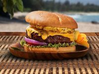 A juicy hamburger covered in melted cheese and sweet pineapple. It’s not your average hamburger! #LaborDay