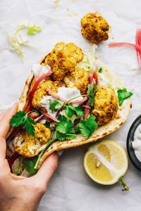 The yummiest warm naan wrap with "shawarma" styled cauliflower! This wrap is filled with flavor, easy to make, and SO so yummy. Enjoy this as a healthy lunch or meatless dinner for any time of the week! asimplepalate.com | #wrap #cauliflower #shawarma #vegetarian