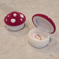 A cute mushroom ring box perfect to store a ring or small earrings Material: Velvet Flocked Ring Box Measurement Approx Width: 2.6in (mushroom cap) Height: 2in This listing is for 1 mushroom ring box (Ring in photo is for display only and not included in your order)