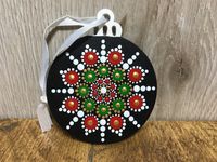 This hand painted wooden Christmas mandala decoration has been sprayed with a gloss varnish and comes complete with ribbon to hang.  This particular bauble decoration is approximately 7cm in diameter.