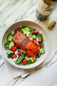 In just 15 minutes, enjoy a delicious salmon, spinach, and strawberry salad made with our NEW bourbon-glazed salmon. The fillets are the perfect blend of sweet and savory with guaranteed great results. For the salad, combine baby spinach, sliced strawberries, diced avocados, sliced Persian cucumbers, shallots, crumbled feta, toasted pine nuts, drizzle with balsamic dressing, and top with Omaha Steaks Bourbon-Glazed Salmon Fillet. Get this and more salmon recipes and cooking tips on our blog.