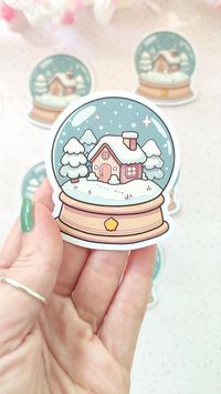 Capture the magic of winter with this adorable snow globe sticker featuring a charming winter scenery in a whimsical anime style! Perfect for decorating your laptop, planner, water bottle, or notebook, this sticker brings a cozy, festive feel to any surface. Made from high-quality, waterproof vinyl, it's designed to be durable and long-lasting while keeping its vibrant colors and intricate details. Ideal for anime lovers, winter enthusiasts, and anyone who enjoys cute, seasonal designs, this sno