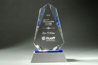 Featuring this elegant Vortex award chosen for Ruoff Mortgage. With its understated blue accent and modern spear shape, the Vortex exudes sophistication and curb appeal. Crafted from beautiful optic and blue crystal, set atop a sleek aluminum base, and personalized with sandblast etching, this award is designed to inspire greatness.