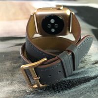 Charcoal Gray Double Wrap Apple Watch Band by Juxli Home.  Handmade, stylish leather strap with rose gold hardware on a 40mm Apple watch on a canvas with a black and gray painting. #applewatchbandleather #applewatchseries4 #applewatchstrap #applewatchband #juxlihome