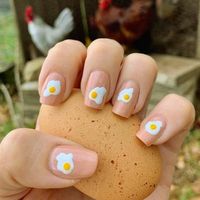 These simple beige nails with a cute omelet pattern can add a beautiful, funny element to your Easter brunch. This unique design, perfect for any Easter morning gathering, will undoubtedly bring a smile to everyone's face.