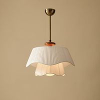 The design of Bellevue Pendant Lamp is inspired by the elegance and romance of the French countryside. Its unique double-layer wavy lampshade design, combined with warm off-white fabric, creates a soft light effect.