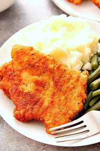 Pork Schnitzel - crispy and juicy schnitzel made with thin pork loin cutlets, lightly breaded and fried to golden perfection. Pure comfort food at it's best!