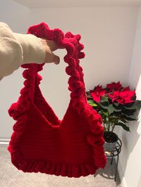 Flounced crochet bag in cherry red.  Handmade using 100% acrylic yarn.  Cold hand wash.