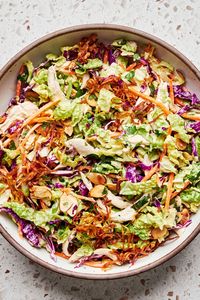 Crunchy green and red cabbage serves as a colorful backdrop for this miso-ginger slaw with shredded chicken. There’s lots of great flavor and texture in this hearty slaw.