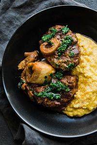 This Osso Buco Recipe of slow-braised veal shanks with vegetables, tomatoes, wine, and stock is fall-off-the-bone good.