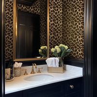 Introducing the Presley Wallpaper. This bold wallpaper features a realistic leopard print pattern, offering a striking, wild aesthetic. The rich, natural tones of golden brown and black give it a luxurious, textured appearance, perfect for adding a touch of exotic glamour to any space. Ideal for accent walls, this design brings a fierce, fashion-forward statement to modern interiors. 24" Pattern Repeat