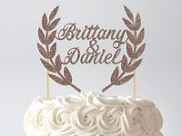 This Laurel Wreath Cake Topper is perfect for a botanical or Grecian theme wedding cake, bridal shower, engagement, anniversary, vow renewal, and more! Its personalized with 2 names (or any text), making it truly one-of-a-kind. Available in a variety of glitter and metallic foil colours. Personalized Cake Topper, Laurel Wreath, Leaves, Grecian Wedding, Greek, Botanical Engagement, Anniversary, Script Calligraphy, Glitter, Metallic Foil, Gold, Silver, White, Black, Green, Blue, Red, Pink, Purple