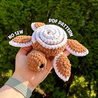 Crochet a no-sew amigurumi cinnamon roll turtle with this PDF pattern. In this pattern I include step by step instructions, photos and links to video tutorials to set you up for success when creating a plushie with one of my patterns. This is not a finished plushie, but a pattern for you to make your own plush. This product is best suited for someone who knows how to read patterns and has a basic understanding of amigurumi style crochet English Pattern, US Crochet Terminology  Finished Plushie f