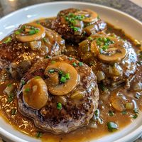 🥘 Comfort food at its best! Try our Slow Cooker Salisbury Steaks tonight! #EasyDinners 🍽️ Slow Cooker Salisbury Steaks 🛒 Ingredients: Ground beef: 1 lb Bread crumbs: 1/3 cup Egg: 1 Onion soup mix: 1 packet Mushroom soup: 1 can Milk: 1/4 cup Water: 1/2 cup 👩‍🍳 Instructions: Mix: Combine beef, bread crumbs, and egg. Form into patties. Cook: Place in slow cooker. Top with soup mix, milk, and water. Set: Cook on low for 5 hours. 🥘 Savor the flavors of homemade comfort with our easy slow cooke...