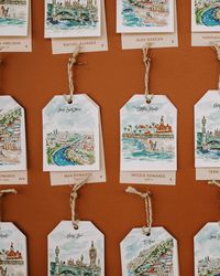 Here's a unique seating chart idea! Custom watercolor hang tags that showcase your favorite spots! Each tag beautifully captures a special location, adding a personal and artistic touch to the celebration. Perfect for guiding guests while telling your story through meaningful destinations. 🌍  #seatingchartideas #placecards #weddinginspo #weddingplanning