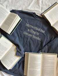 "Let everyone know that you're introverted but 100% willing to discuss books by wearing this adorable crewneck or t-shirt! This item's design is embroidered onto an indigo crewneck made of 50% cotton and 50% polyester or indigo t-shirt made of 100% cotton. Additionally, each crew or tee has a sleeve detail reading \"just keep reading.\" Crews and tees are preshrunk, so don't worry about shrinkage in the wash! For sizing information, please refer to the size chart provided in the listing. Because each crewneck is handmade by me, the current processing window for orders (not including shipping time) is 4-6 weeks. Please understand that I unfortunately am not able to offer expedited or rushed processing at this time.  Do you need a size not offered on the listing? Do you want a custom color c