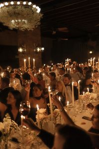 Wedding-guests-raising-a-glass-at-candlelit-wedding-reception-at-the-Bowery-Hotel