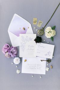 Purple and white wedding invitations with letterpress and floral illustrations