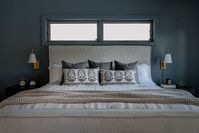 Blues, grays, and gold touches. Plush pillows and bedding. Fabric upholstered head board. Bedside tables and lights. Cozy & relaxing.