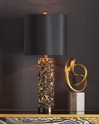 This column table lamp is a plethora of distressed gold on black blooms with brass. Finish is reminiscent of a repousse vase. Approx. 32"H x 13.5"L x 13.5"D. Shade dimensions, 13.5"Dia. x 12.5"T. 120 voltage/1 bulb 150 watts/switch on socket. Composition steel. Imported. Boxed weight, approximately 15 lbs.