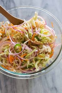 Curtido is an authentic Salvadoran cabbage slaw or relish made with finely shredded cabbage, red onion, carrot, spices, and vinegar. 