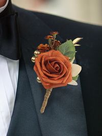 Size: 4.5" tall Package: Burnt Orange Boutonniere*1 Materials: foam and silk flowers Detail: These boutonnieres are perfect for weddings, as they come with pins that can be attached to the lapel of the groom, best man, or any male guest to enhance their overall look and add to the wedding theme.The peach color of these boutonnieres is perfect for a fall wedding or any other autumnal celebration, as it complements the warm hues of the season and adds a pop of color to any suit or tuxedo.In additi